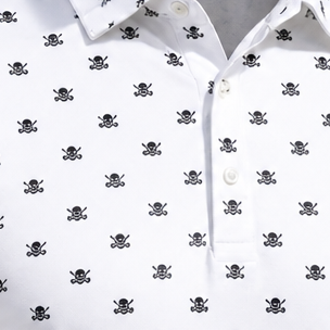 Close-up of white buttons and black skull motifs on a white polo.