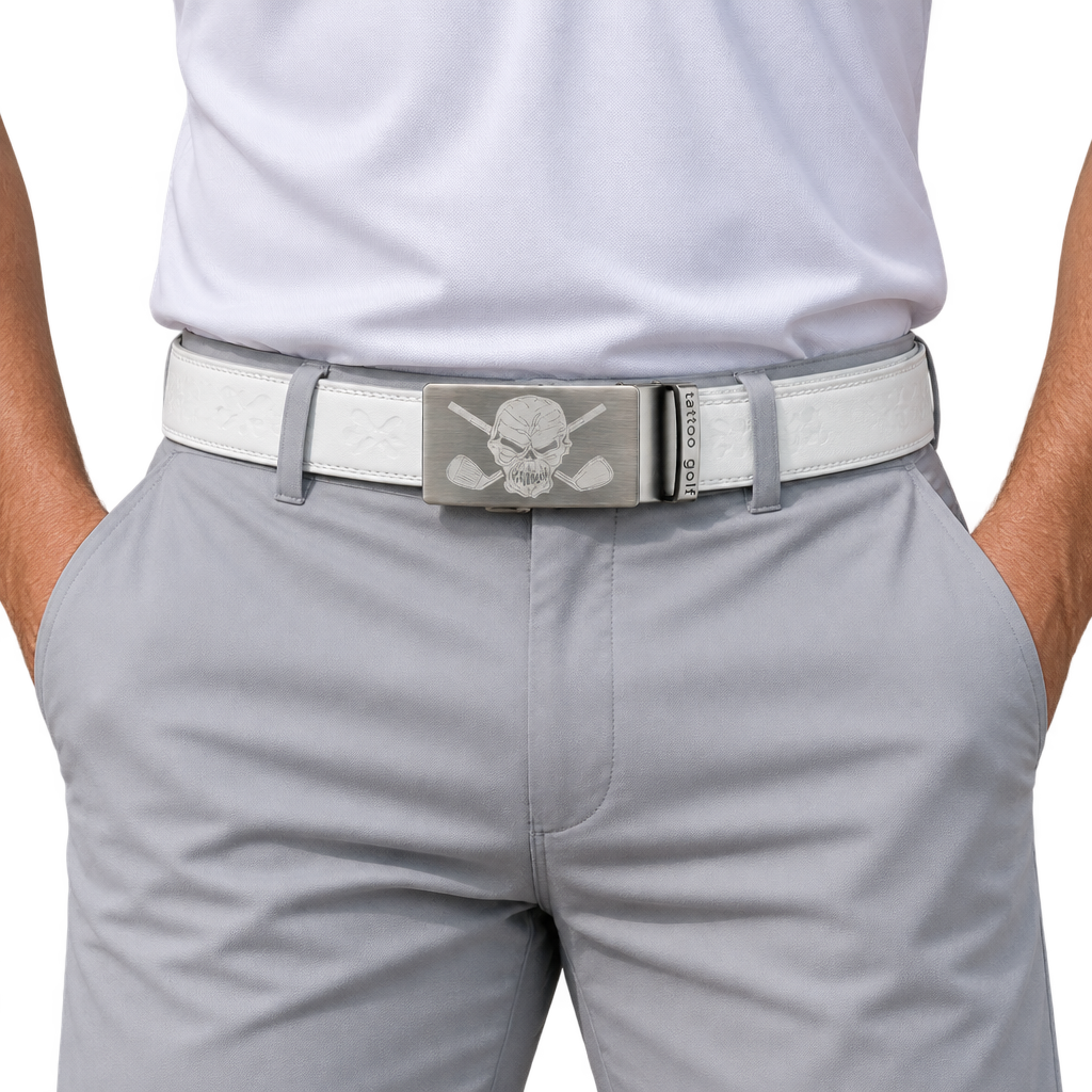 White skull-buckle belt worn with light grey trousers.
