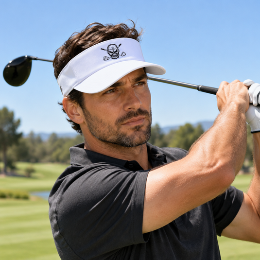 Golfer finishing a swing in a white skull-logo visor.