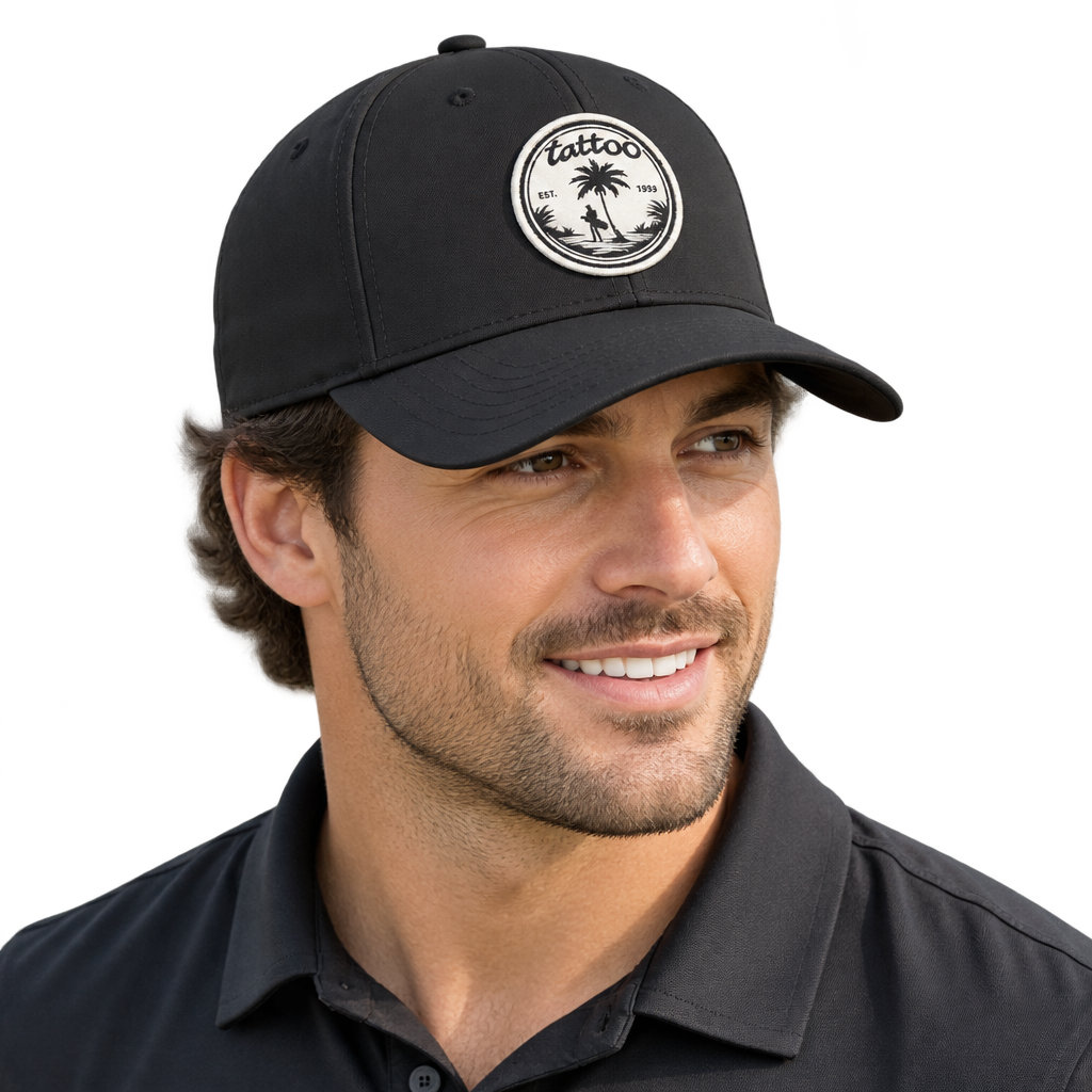 Smiling man wearing a black cap with a round palm-tree patch.