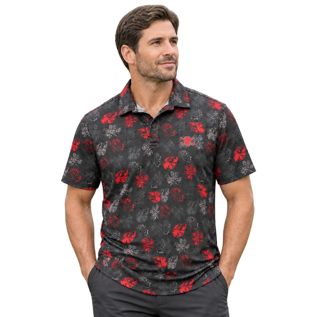 Golfer wearing a black red-and-grey floral polo with hands in pockets.