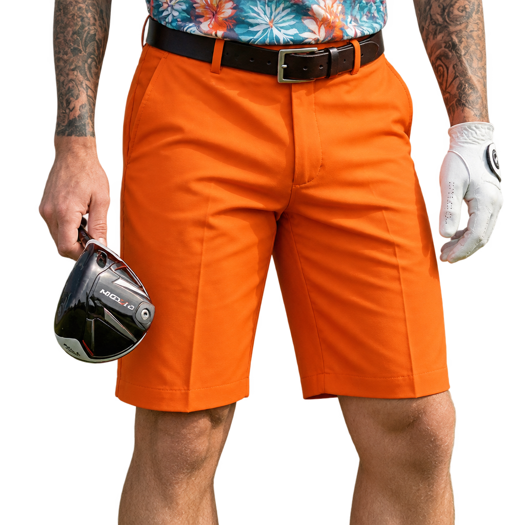 Golfer wearing orange shorts, a black belt and a patterned polo, holding a club and wearing a white glove.