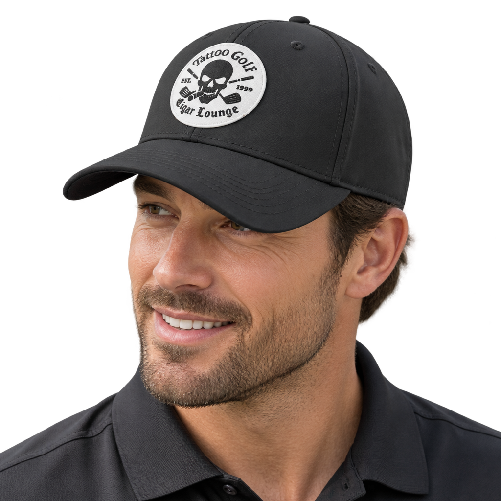 Smiling man wearing a black Tattoo Golf Cigar Lounge patch cap.