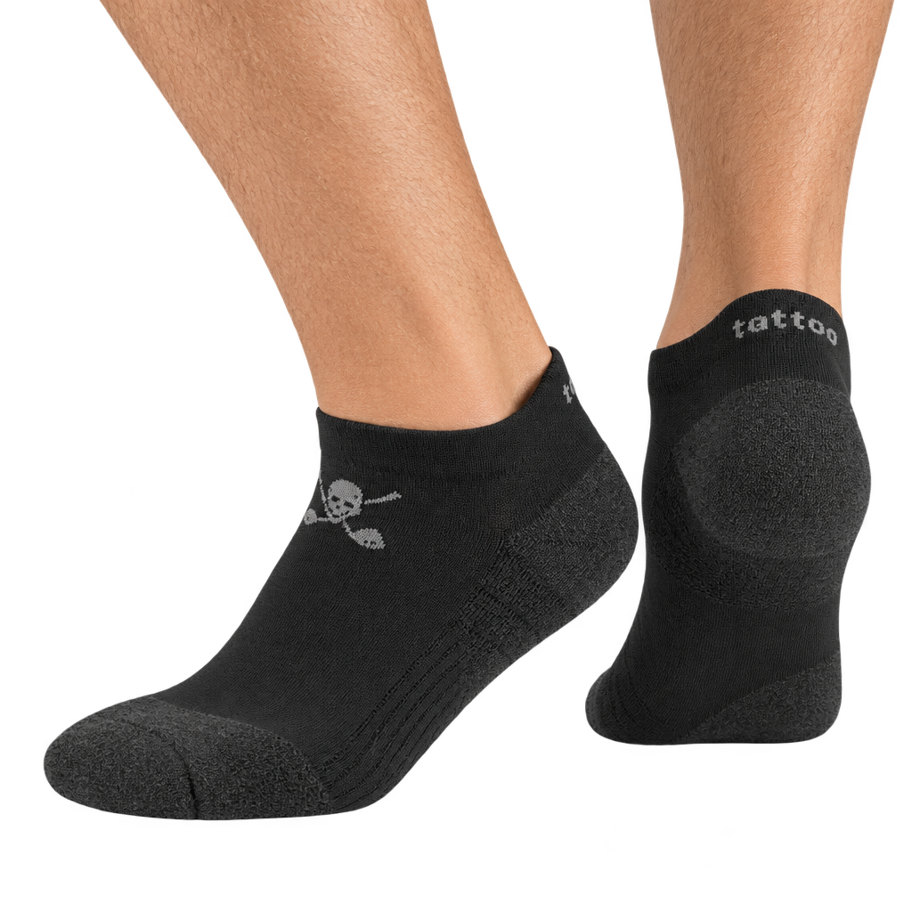 Black low-cut socks worn on feet, with grey heel panels and skull logos.