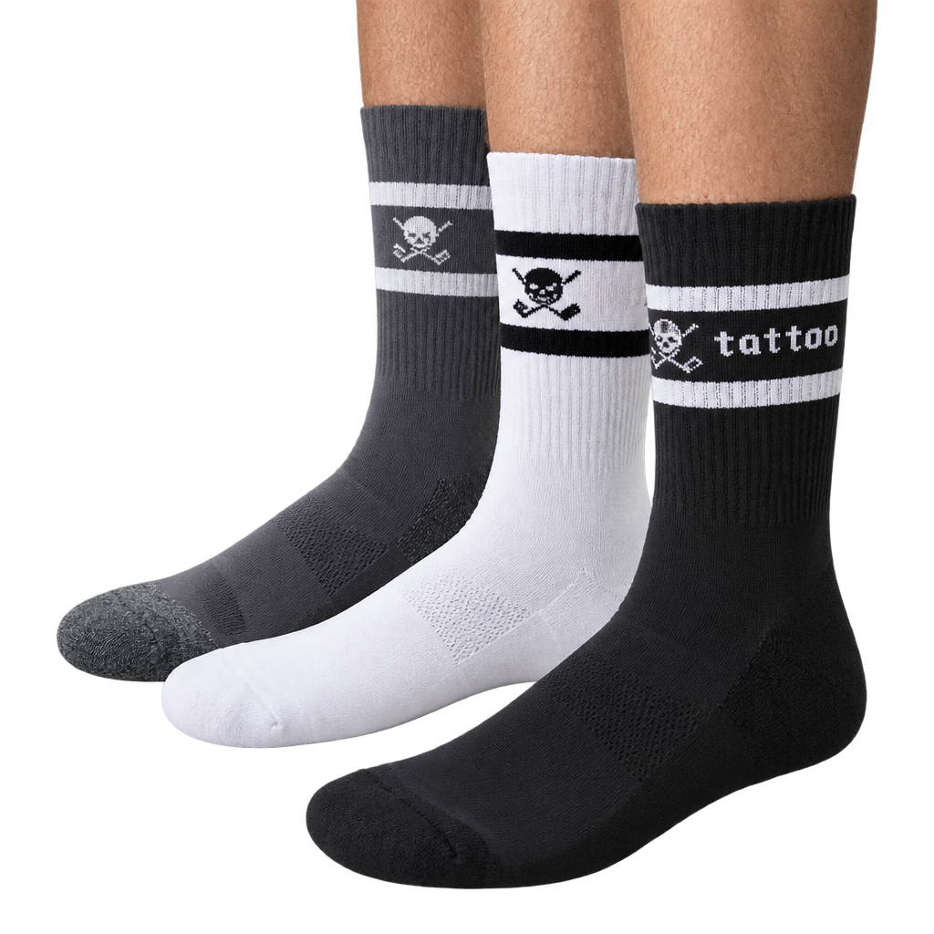Grey, white and black crew socks shown on legs, with striped cuffs, skull motifs and Tattoo lettering.