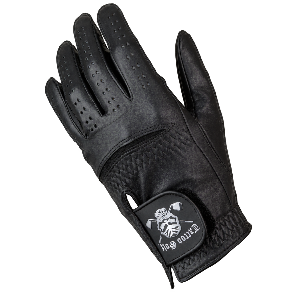 Black golf glove with finger perforations and a white skull-design wrist patch.