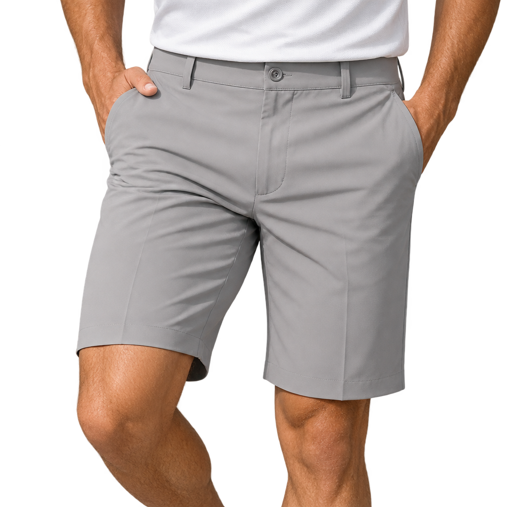 Front view of grey golf shorts worn with a white polo, with one hand resting in a pocket.