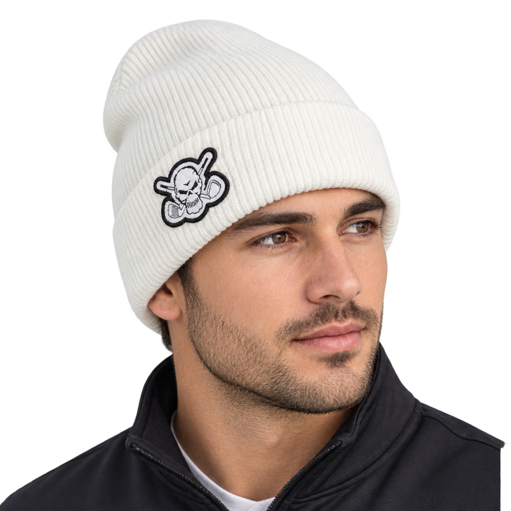 Man wearing a white rib-knit beanie with a skull patch.