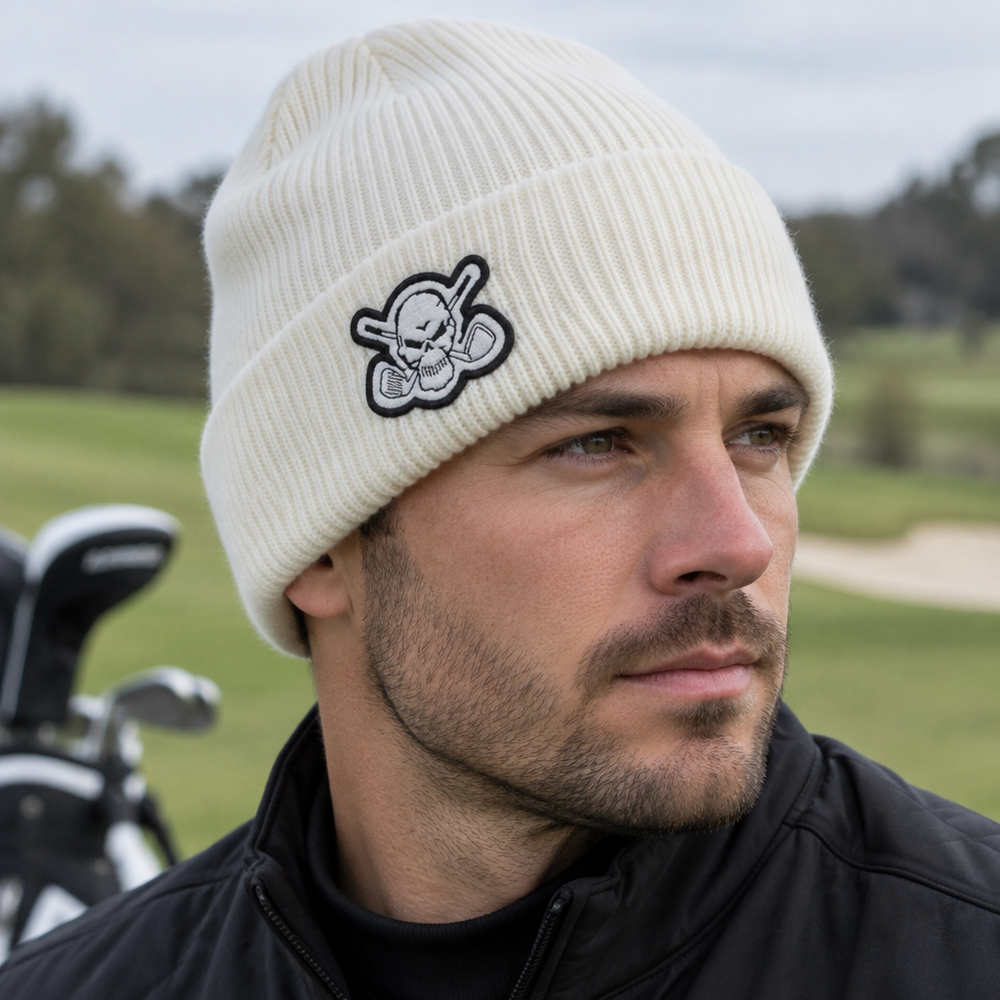 Close-up of a golfer wearing a white skull-patch beanie.