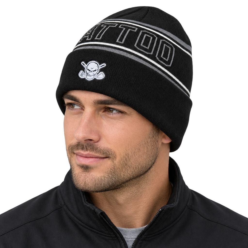 Man wearing a black beanie with outlined TATTOO lettering and a white skull patch.
