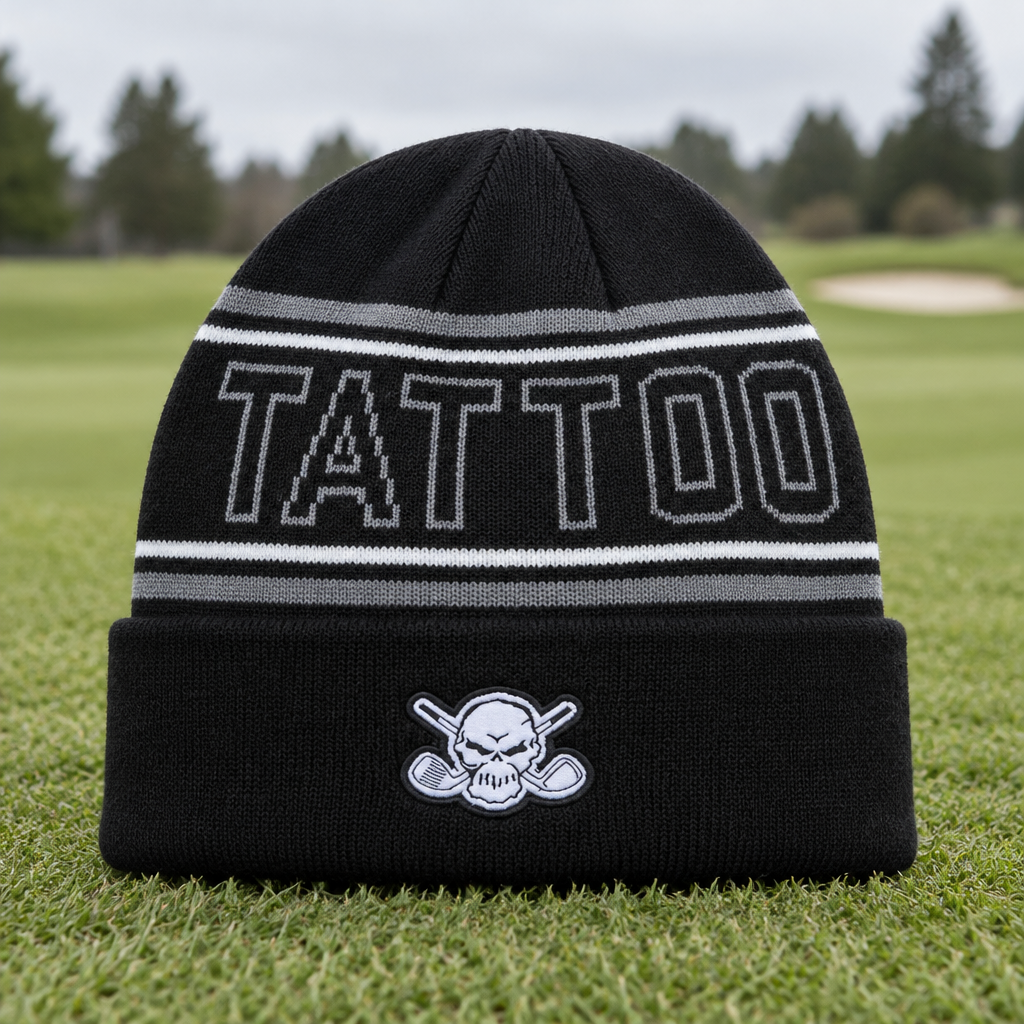 Black TATTOO-lettered beanie standing on grass.