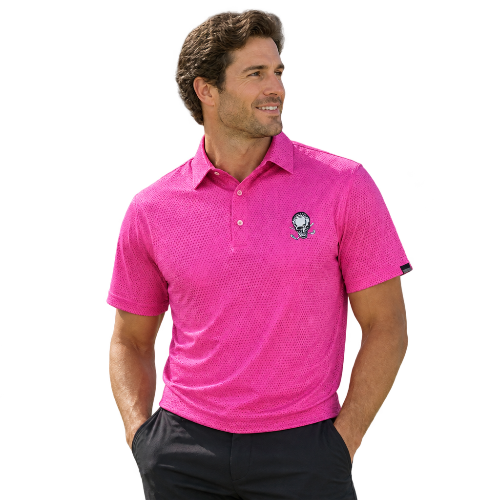Man wearing a pink tonal-patterned polo with a skull chest logo and black trousers.