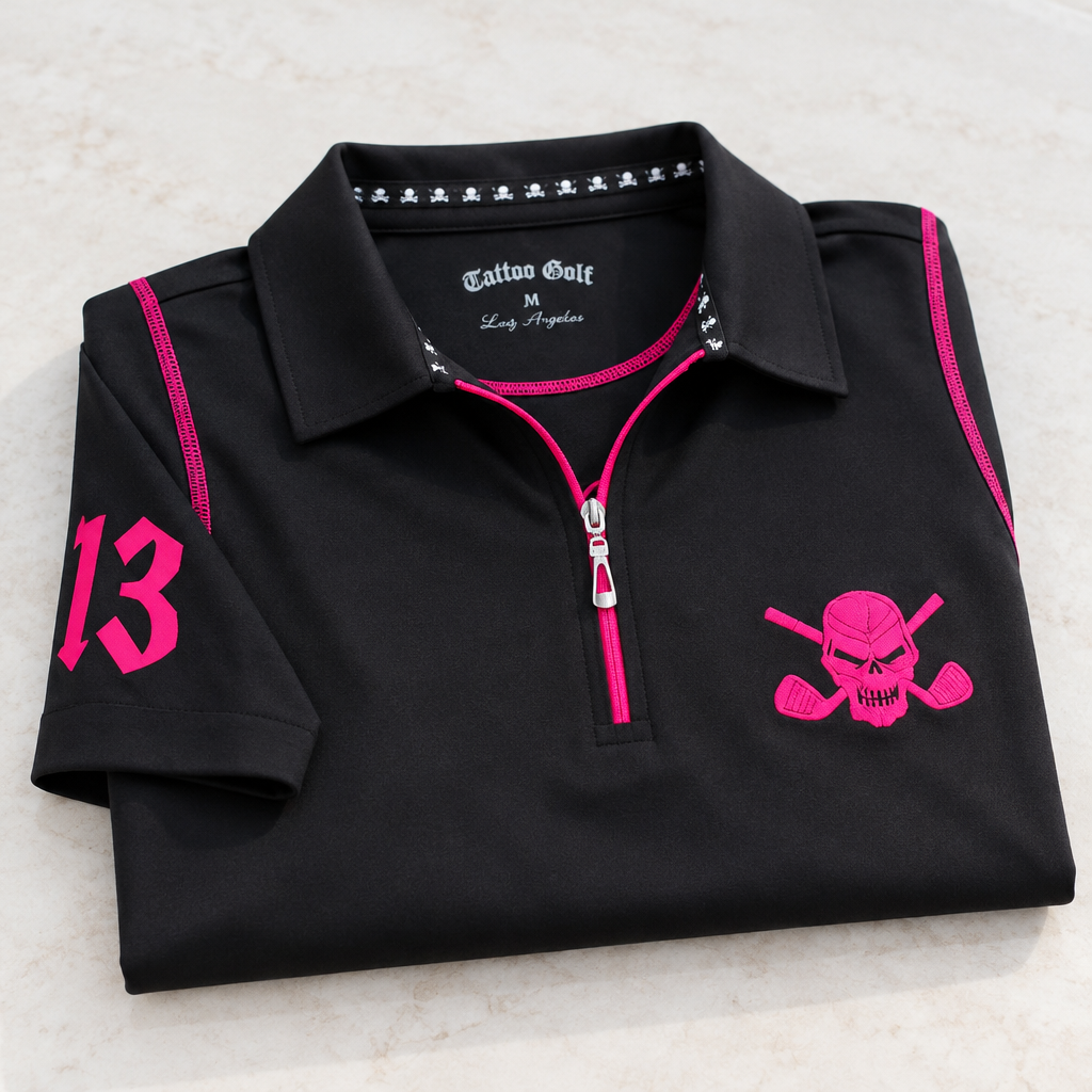 Folded black quarter-zip polo with pink details and skull chest logo.