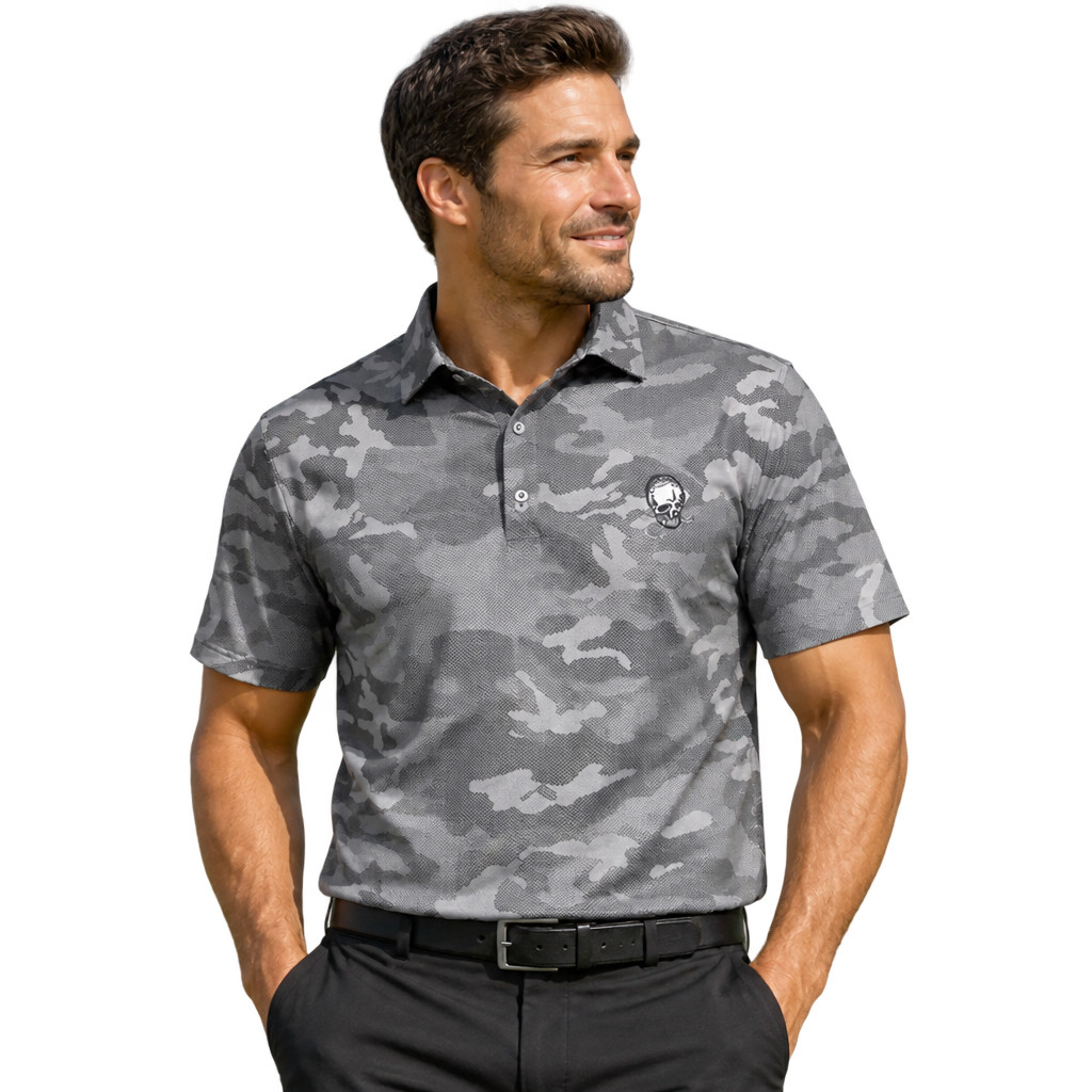 Man wearing a grey camouflage polo with a small skull chest logo and black trousers.