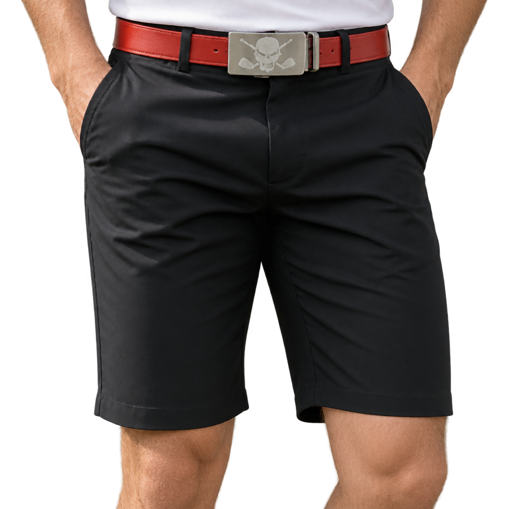Front view of Tattoo Golf OB ProCool black golf shorts worn with a red skull-buckle belt, with hands in the pockets.