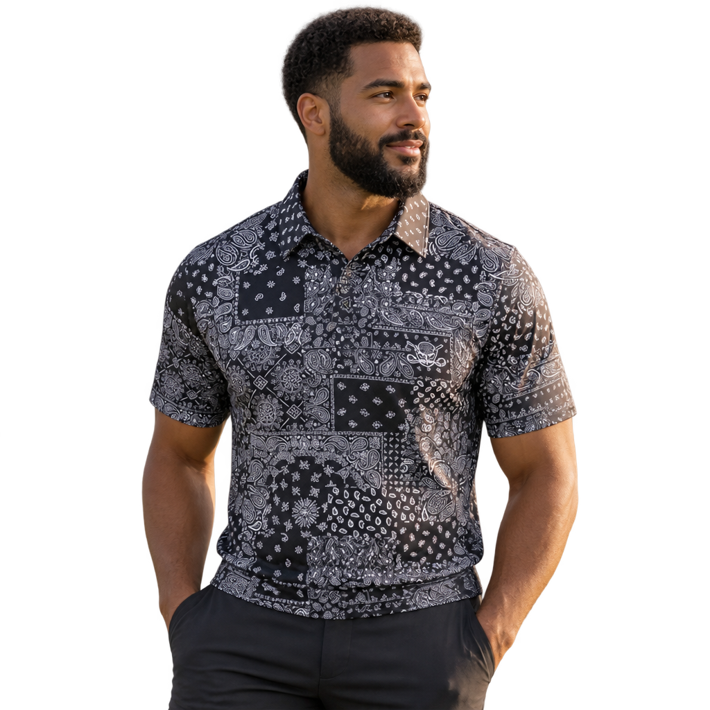 Man wearing a black and grey bandana-print polo with dark trousers.