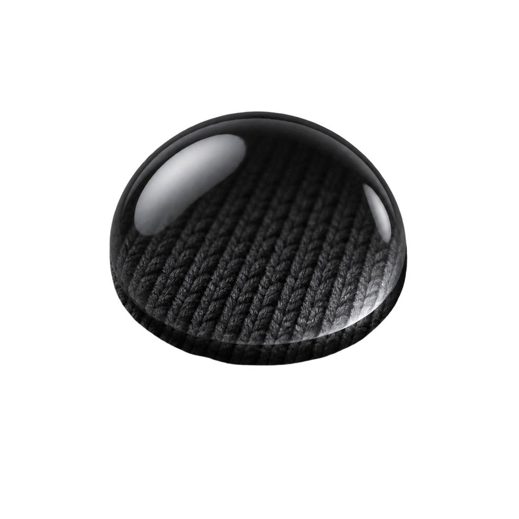 Illustration of a clear water droplet over black knitted fabric.