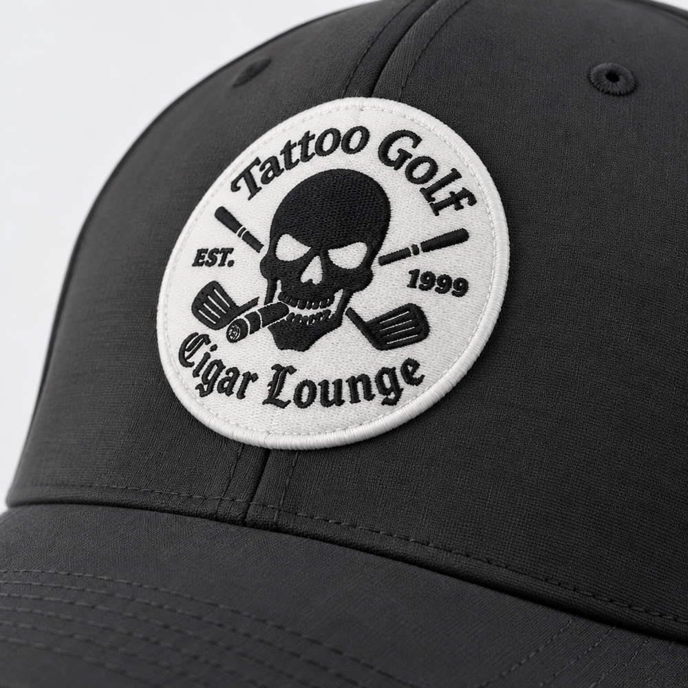 Close-up of a circular Tattoo Golf Cigar Lounge patch with a skull, crossed clubs and EST. 1999 text.