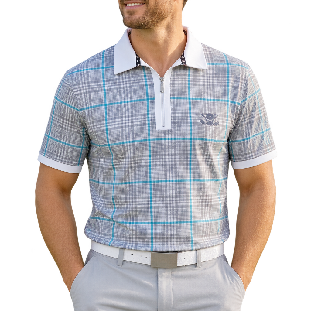 Man wearing a grey and blue plaid golf polo with a white collar and cuffs, paired with white trousers.