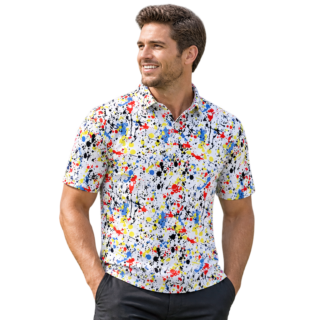 Man wearing a white golf polo with multicolored paint-splatter graphics.