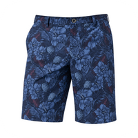 Front view of blue tropical-floral golf shorts on a white background.