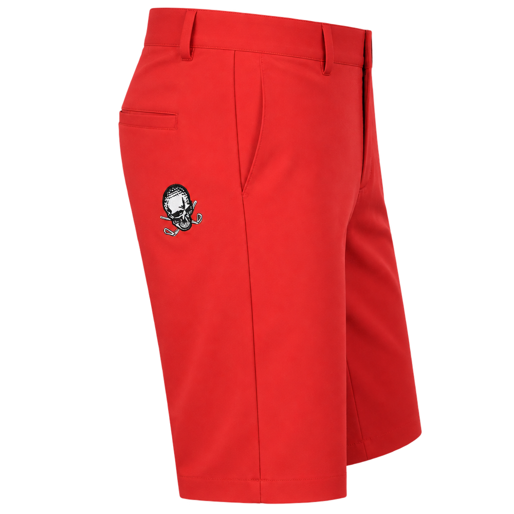 Angled view of red golf shorts showing a rear pocket, belt loops and a small skull logo.