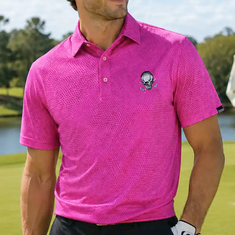 golfer wearing a pink polo shirt with a tattoo logo on a golf course