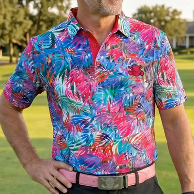 Tattoo Golf Summertime men's multicolor polo, worn on a golf course with the colorful pattern visible.