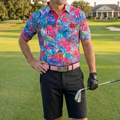 golfer in colorful golf shirt and black shorts holding a golf club on a golf course